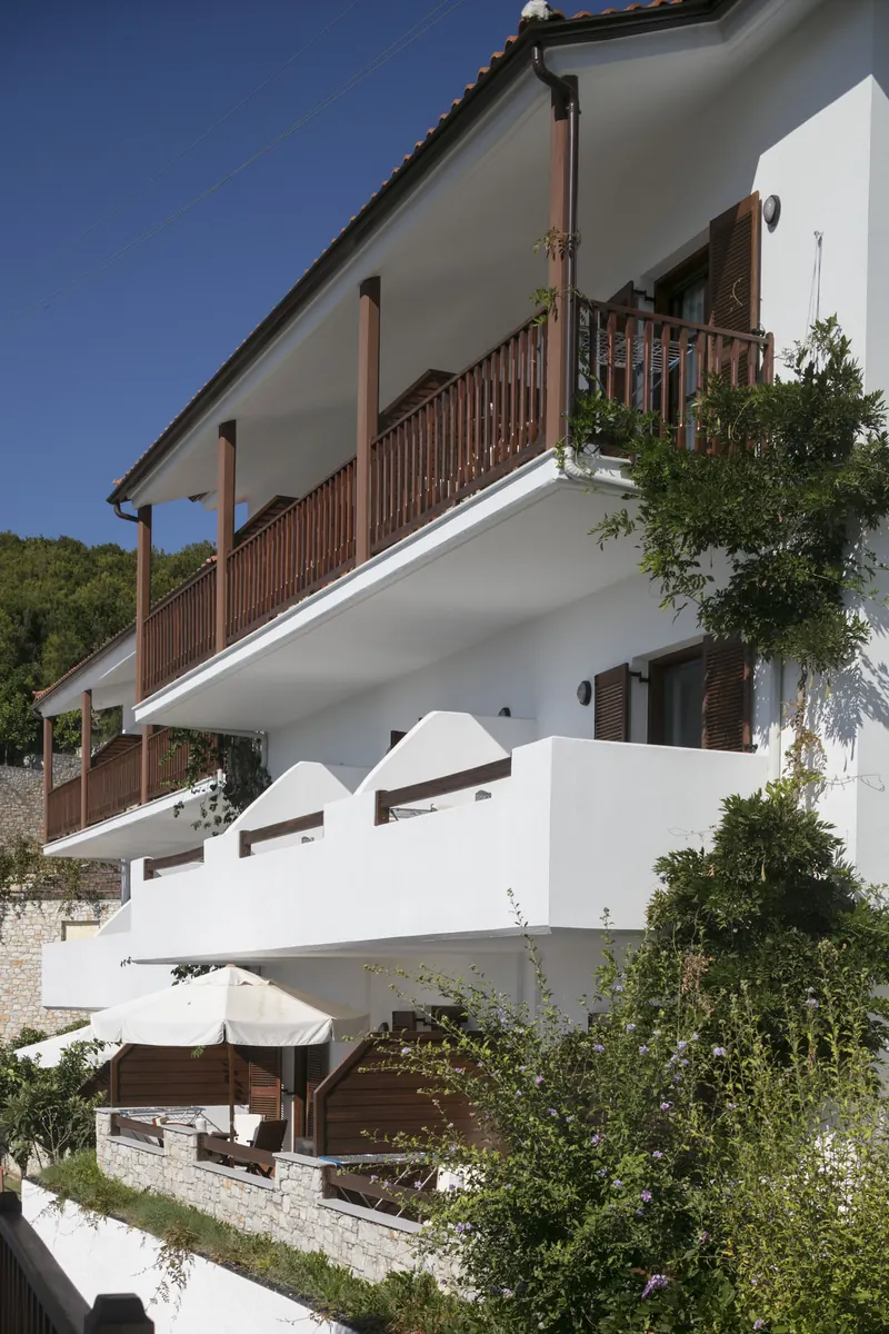 Timber balconies stacked up the hillside among the pines